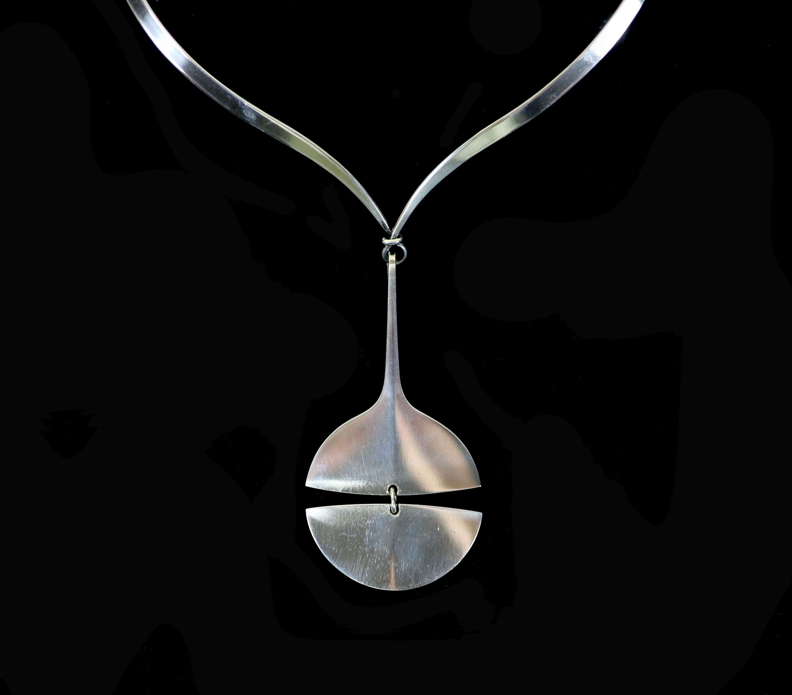 A Georg Jensen sterling silver drop pendant, no. 144, together with a Georg Jensen Torun sterling silver torque necklace, no. 169